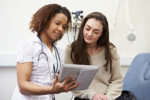 a doctor giving HPV counseling to a patient