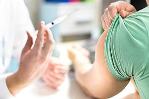 a woman being administered a vaccination to protect against HPV