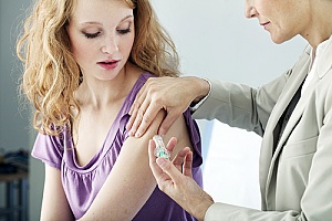 a woman being issued a Gardasil vaccination