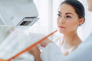 woman receiving a mammogram as part of a breast care appointment