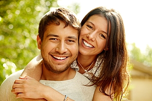 Happy couple smiling on sunny day