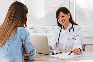 Woman consulting doctor at desk
