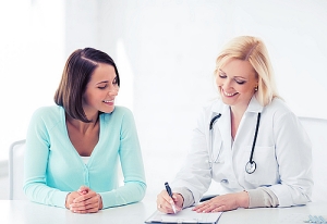 Young woman consulting doctor and reviewing results