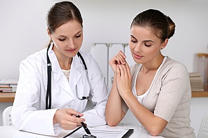 doctor talking to young woman about contraceptive care