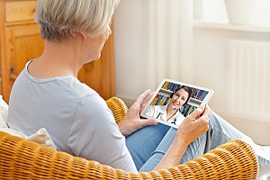 Woman consulting doctor on tablet telemedicine