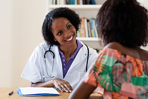 Smiling doctor talking to patient 