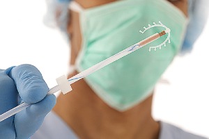 A doctor holding a Copper IUD. There are two types of IUDs available in the US.