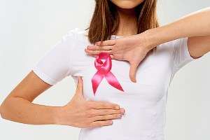 woman in white t-shirt with a pink ribbon, the symbol of breast cancer awareness, on her chest.mammogram is one of the best tools available for early detection of breast cancer
