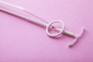 a iud with pink background for IUD recovery time