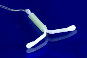 Hormonal IUD on blue background