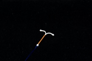copper IUD with black background