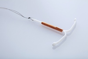 copper IUD on white background