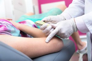 A doctor preparing to insert a contraceptive device. Implanon insertion also has health risk