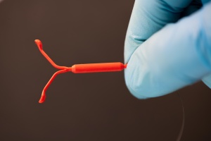 doctor holding a IUD explaining What To Expect After IUD Insertion