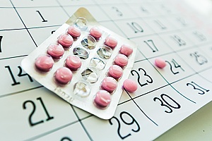 calendar with hormonal contraceptive pills on top of it