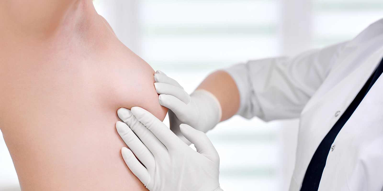 Doctor examining breast of her female patient cancer awareness prevention