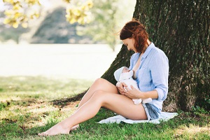 baby eating mother's milk on nature in Breast Care Routine