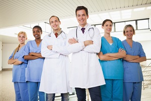 doctors with Nurse Practitioner with arms crossed in hospital corridor