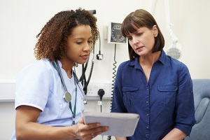 Nurse Practitioner showing patient test results on tablet