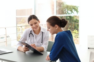 nurse practitioner talking with young patient