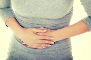 women holding stomach from Dysmenorrhea pain