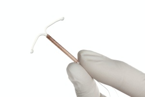 Gynecologist holding iud giving tips on how to make iud insertion less painful