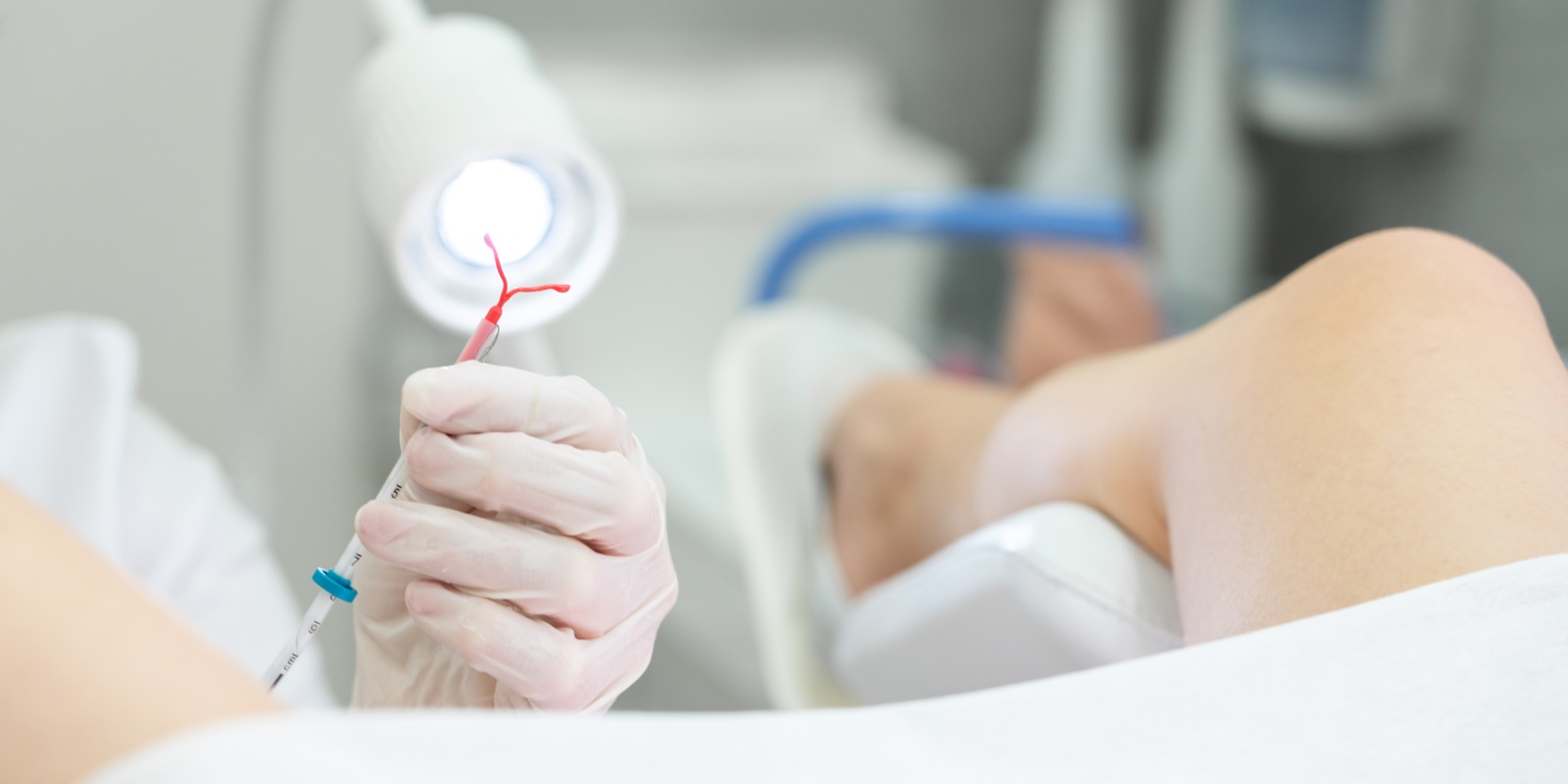 gynecologist holding an iud birth control device before using it for patient