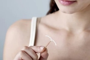 women holding iud device in hand