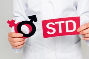 doctor holding male female sign and std card