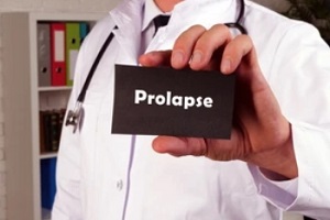 doctor holding prolapse in plate