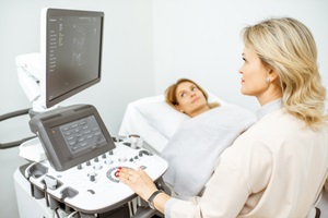 doctor performs ultrasound examination of a women pelvic organs