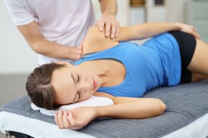 Male therapist helping a woman relieve body pain