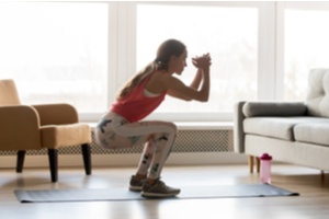 Woman doing squats at home