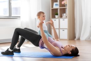 A woman is doing kegel exercise with her baby