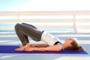 A young woman is doing kegel exercise at home