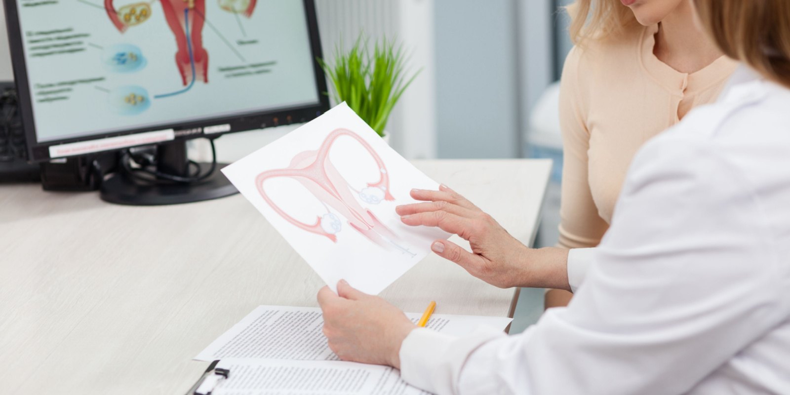 Gynecologist showing causes of vaginal dryness to her patient