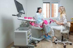 A female doctor prescribing treatment to a woman inside the clinic