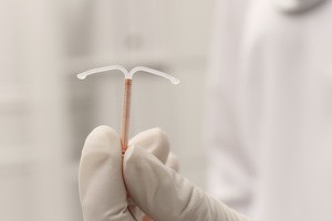A doctor holding an IUD
