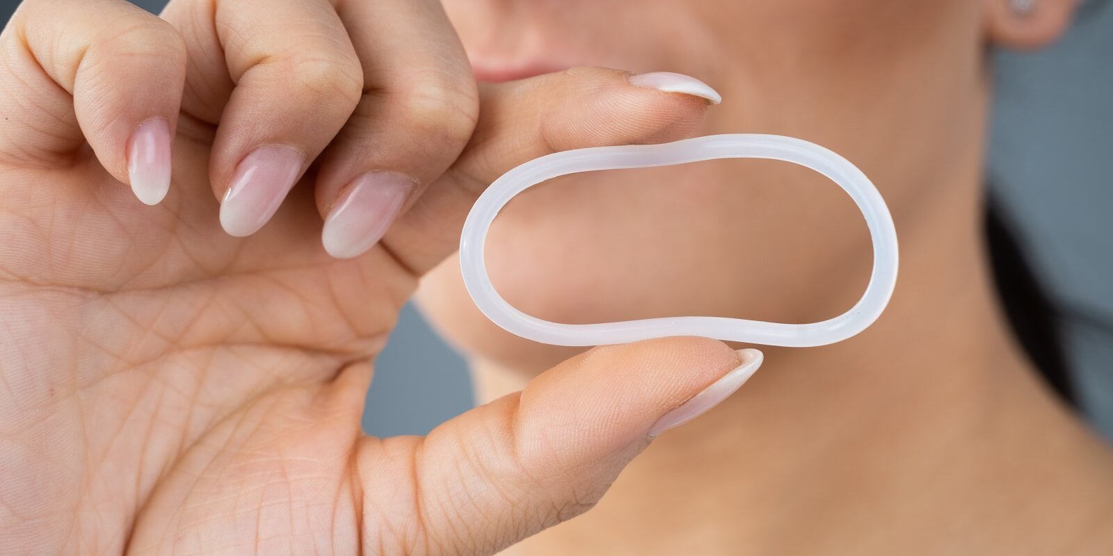 woman holding vaginal ring
