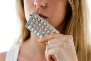 women holding birth control pill