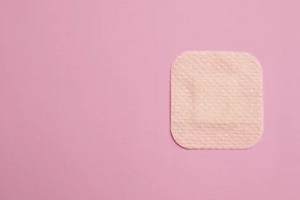 birth control patch in pink background
