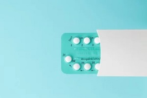 birth control pills on blue background
