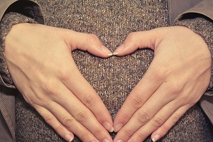 person during heart hand gesture