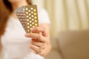 Raleigh women holding birth control pills