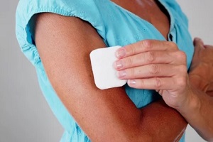  North Carolina women applying birth control patch on arm