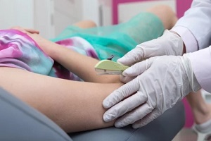 North Carolina OBGYN inserting implant in women body