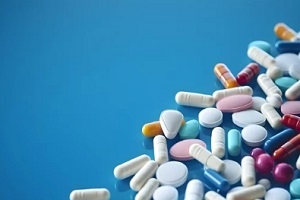 various pills on blue background