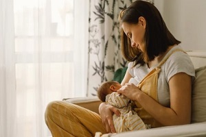 women breastfeeding newborn