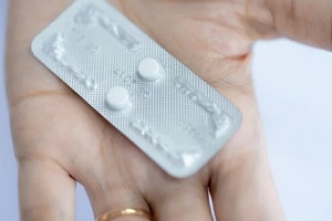 Raleigh, NC women holding birth control pills