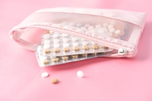 birth control pills on pink background